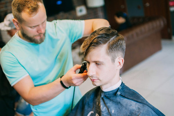 Homme bien coiffé lors d'une séance chez le barbier